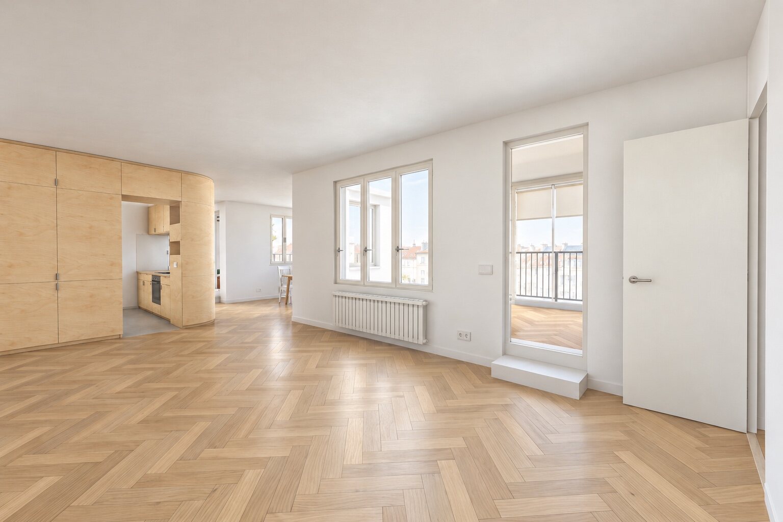 Living room towards the covered terrace, with the kitchen at the back