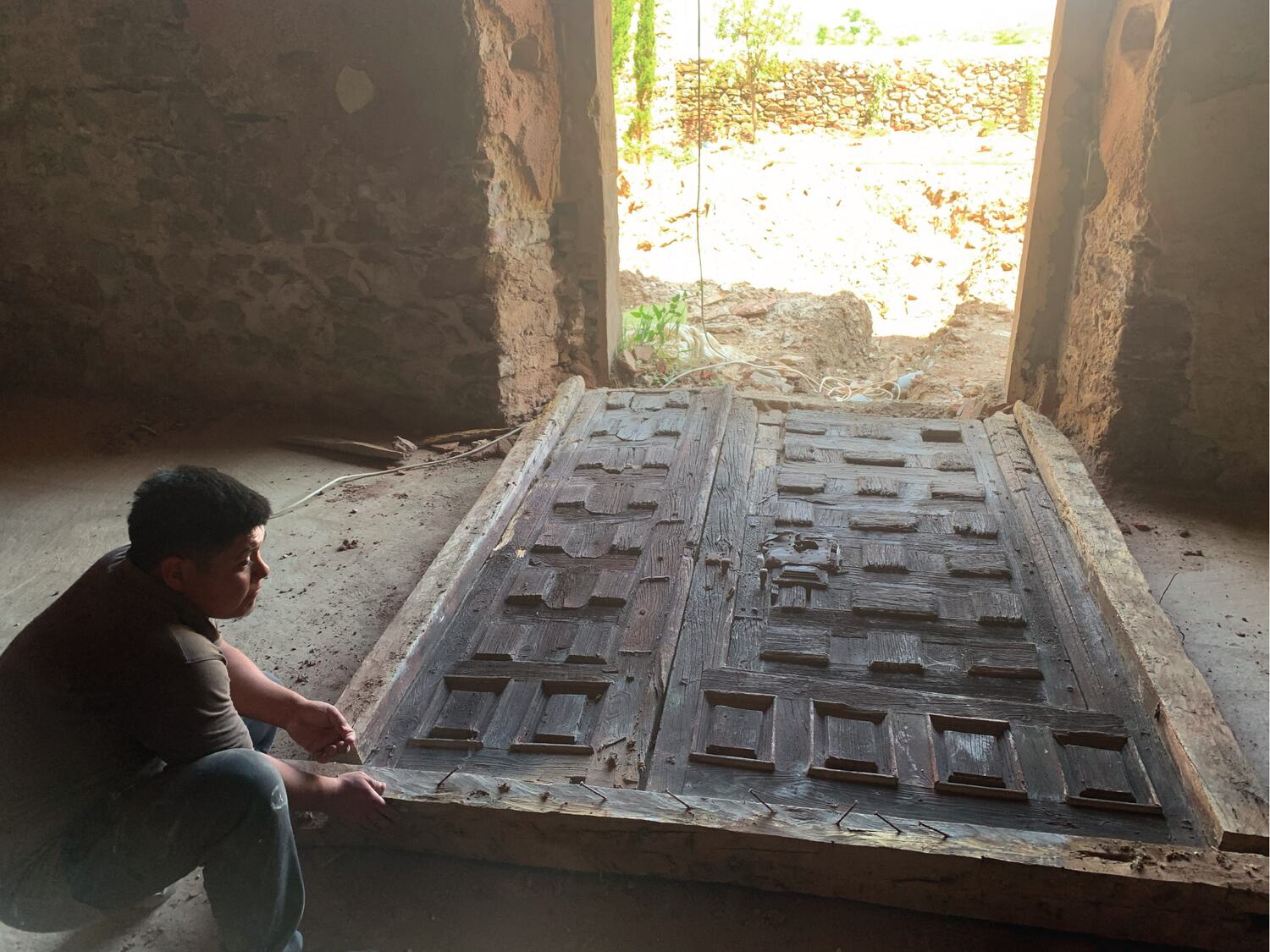 One of the original coffered doors laid down for restoration