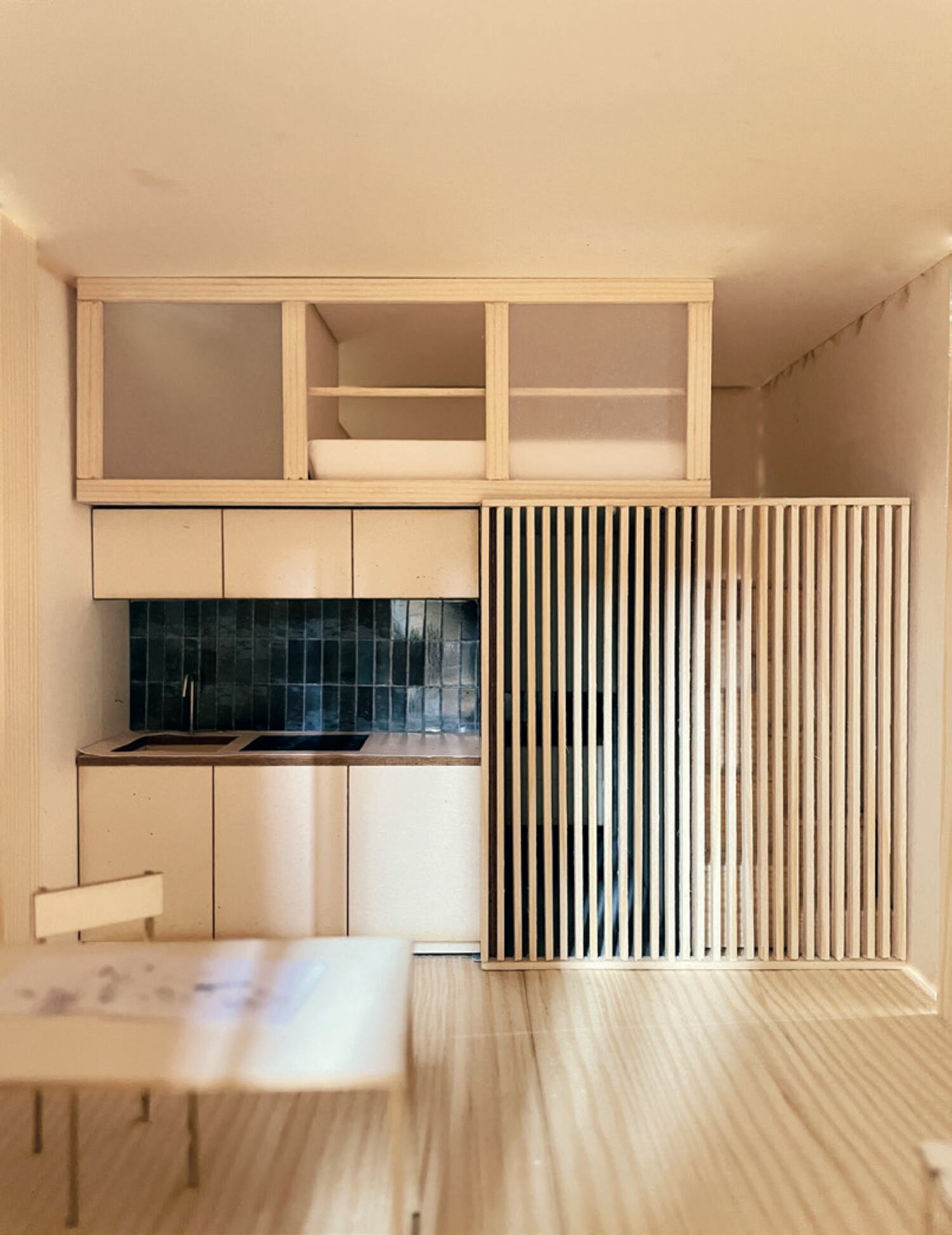 Kitchen of a student unit behind its timber screen